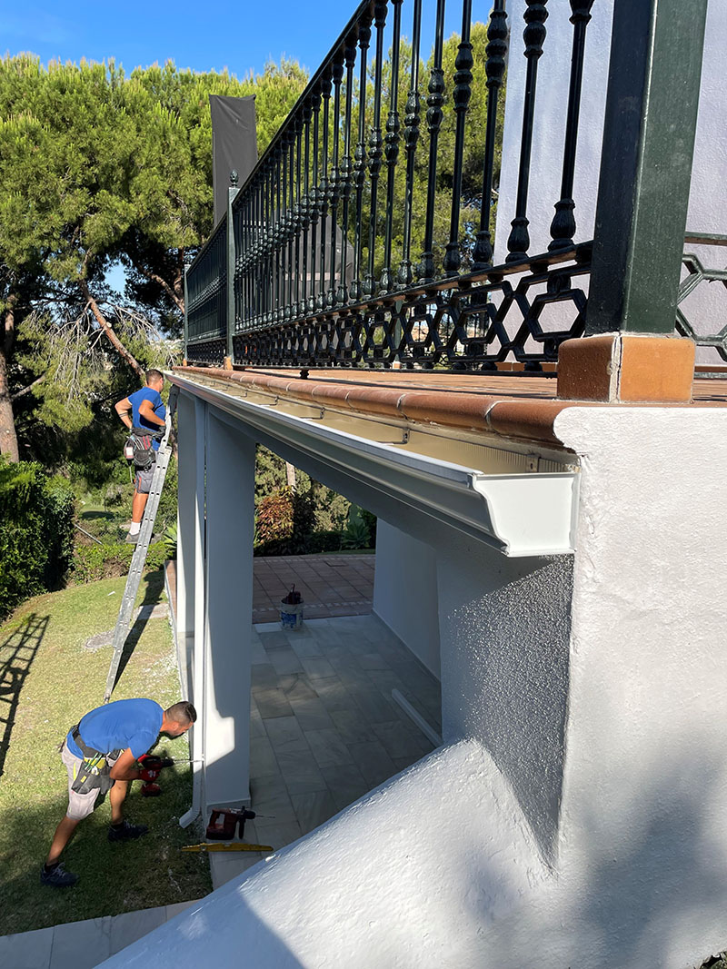 guttering-fitting guttering being fitted to a house in estepona